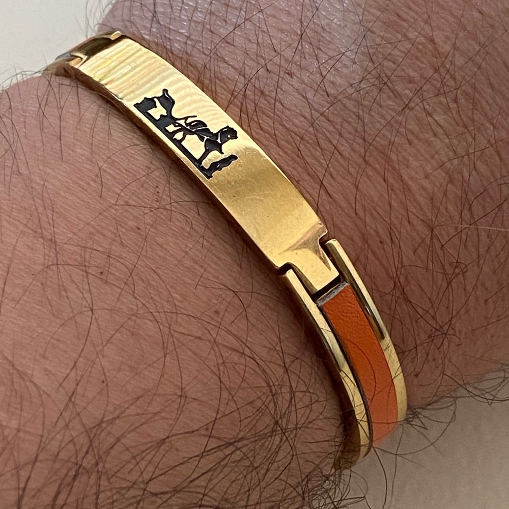 Gold bracelet with orange leather details